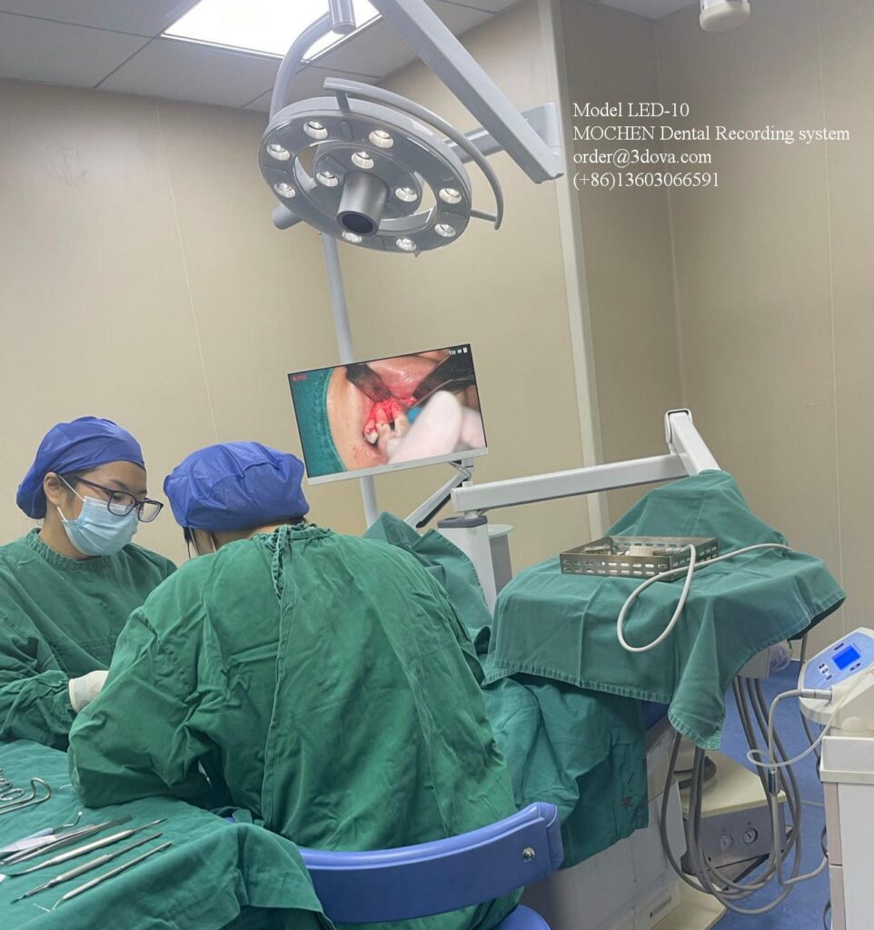 Mochen LED-10 dental recording system displaying a live, high-definition video feed of a dental procedure on a surgical room monitor screen.